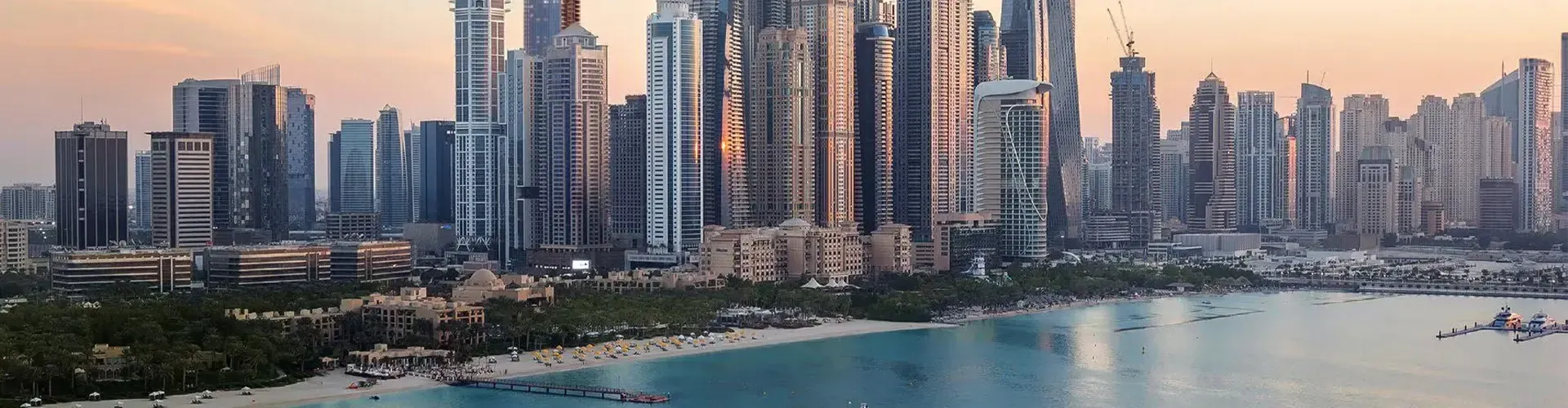 View of high-rise residential towers along the Dubai Marina walk, popular for luxury apartment rentals.
