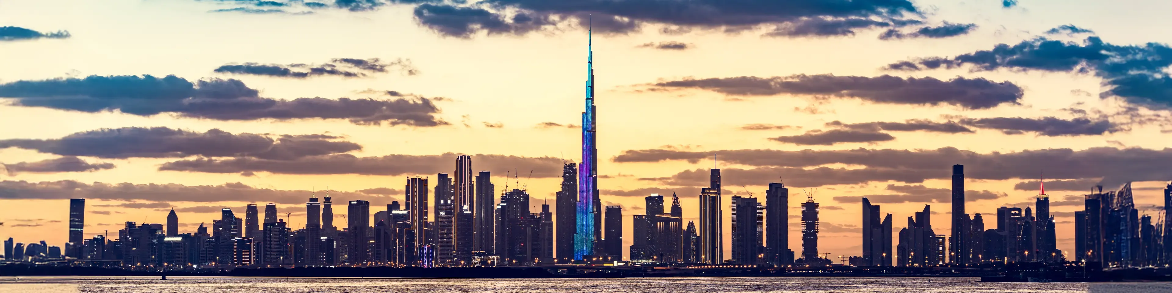 A modern view of the Dubai skyline, illustrating an investor's guide to understanding UAE VAT and corporate tax on real estate.