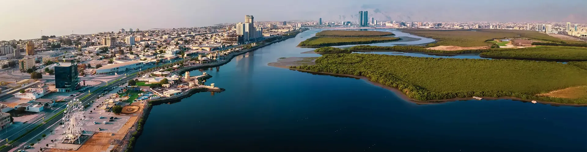 Modern Ras Al Khaimah skyline integrated with green hydrogen energy facilities.